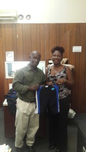 Lincoln Depradine making presentation to Pamela Cherebin